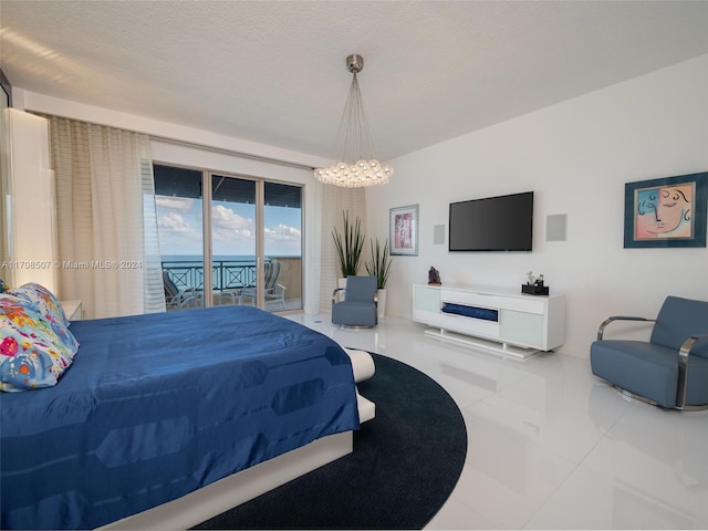 bedroom with access to exterior, a textured ceiling, an inviting chandelier, and tile patterned flooring