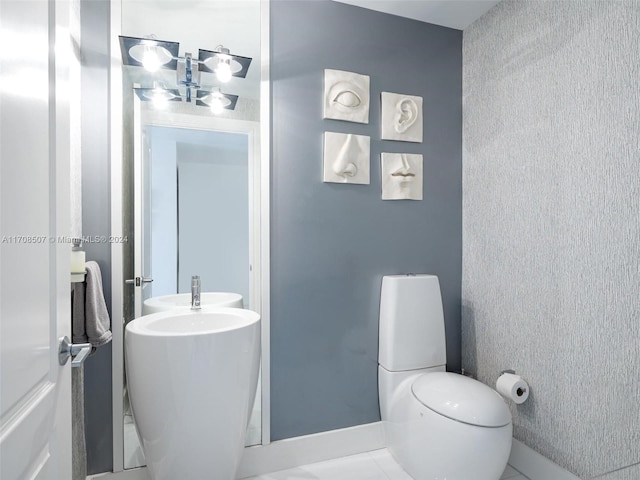 bathroom featuring tile patterned flooring and toilet