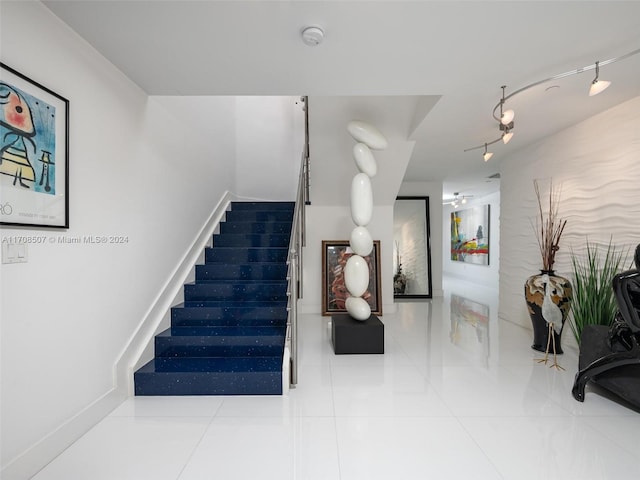 staircase with tile patterned floors