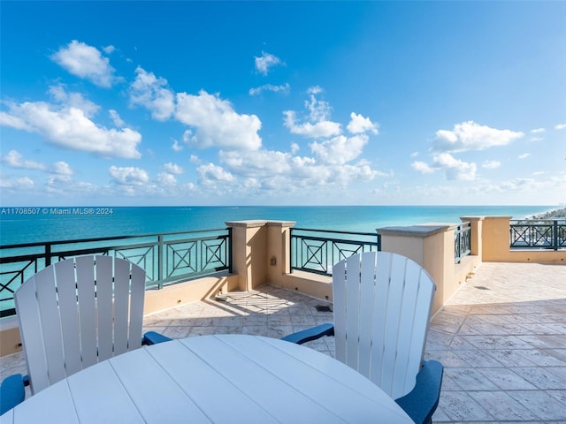 view of patio / terrace with a water view and a balcony