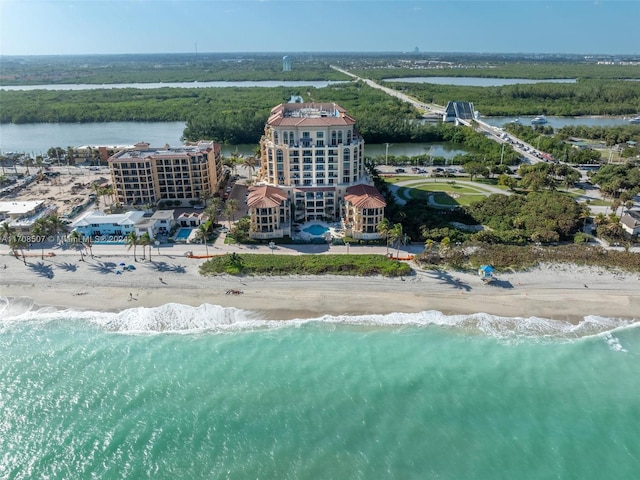 bird's eye view featuring a water view and a beach view