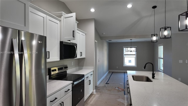 kitchen with white cabinets, sink, stainless steel appliances, and hanging light fixtures