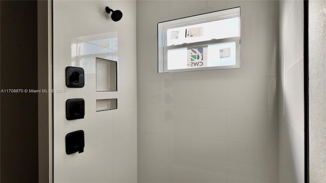 interior details featuring a tile shower