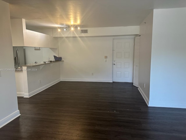 unfurnished living room featuring dark wood-type flooring