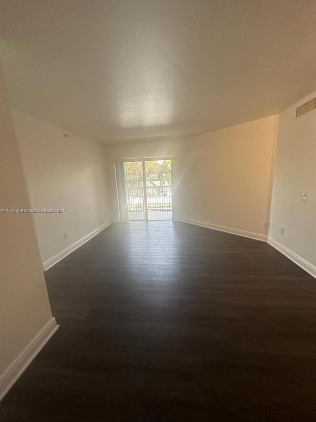 unfurnished room featuring dark hardwood / wood-style flooring