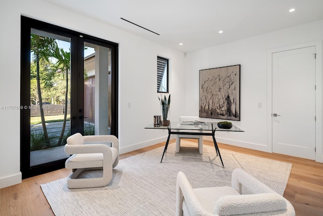 office space featuring french doors and light wood-type flooring