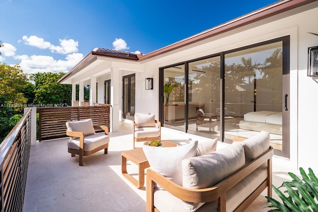 view of patio / terrace with an outdoor living space and a balcony