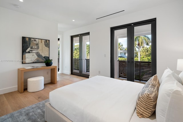 bedroom featuring access to exterior, french doors, and light wood-type flooring