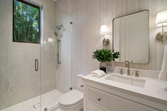 bathroom featuring vanity, an enclosed shower, and toilet