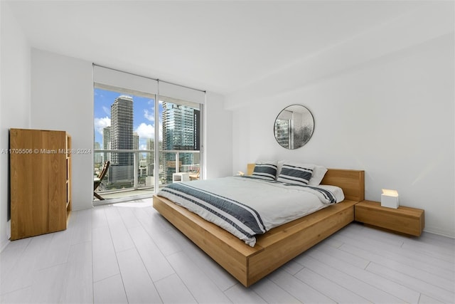 bedroom featuring light hardwood / wood-style floors and access to outside