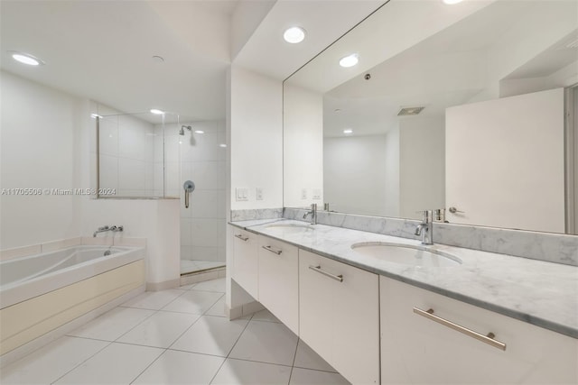 bathroom featuring tile patterned flooring, vanity, and separate shower and tub