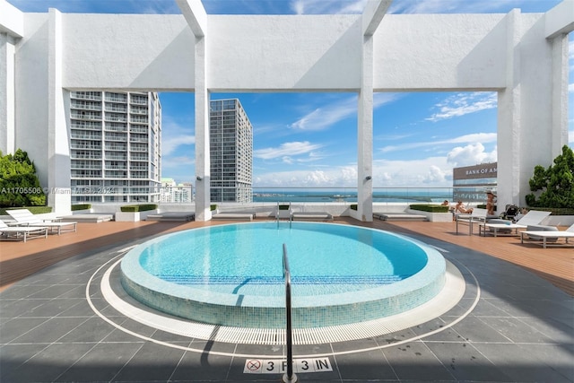 view of swimming pool featuring a water view