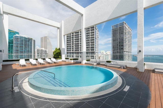 view of pool with a deck with water view