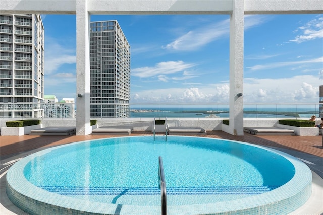 view of pool with a water view