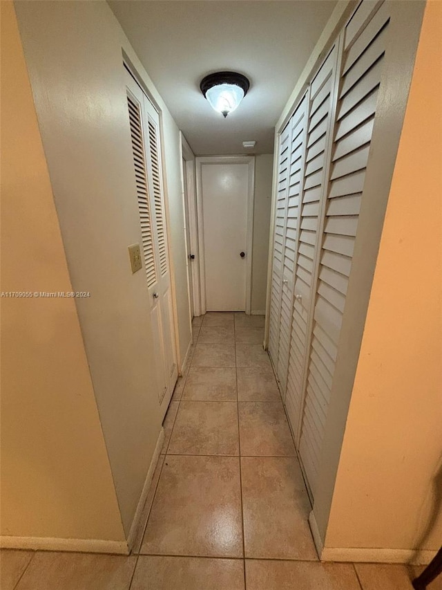 hallway featuring light tile patterned floors