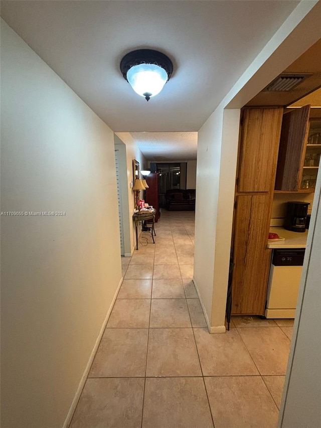 hall featuring light tile patterned flooring