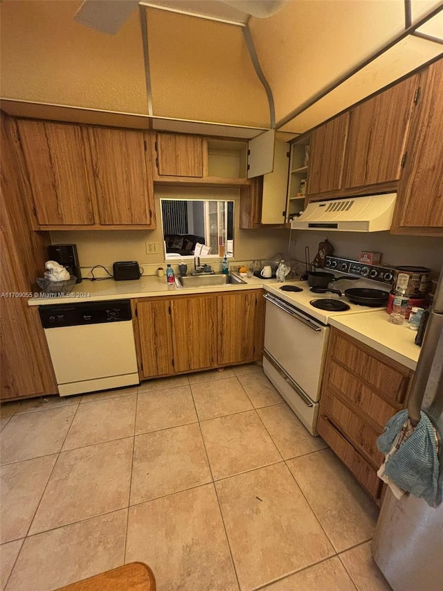 kitchen with white appliances, sink, and light tile patterned floors