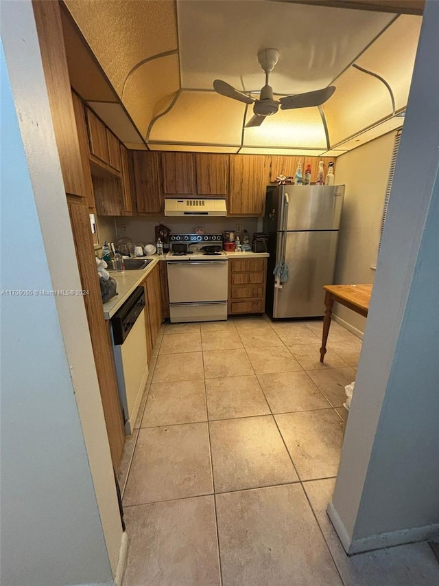 kitchen featuring appliances with stainless steel finishes, ceiling fan, sink, light tile patterned floors, and range hood