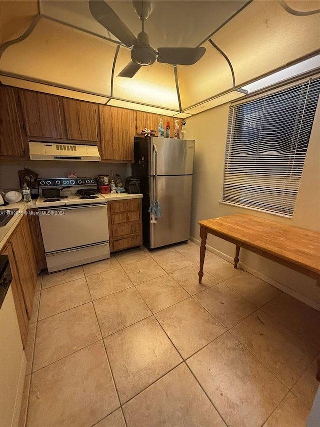 kitchen with white appliances, exhaust hood, sink, ceiling fan, and light tile patterned floors