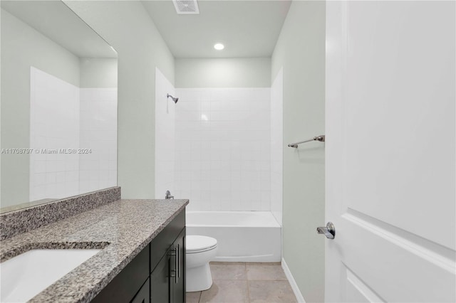 full bathroom with tiled shower / bath, tile patterned flooring, vanity, and toilet