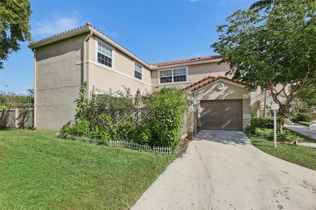 10949 Mainsail Dr, Cooper City, FL 33026 - mediterranean / spanish house with stucco siding, concrete driveway, a tiled roof, and a garage