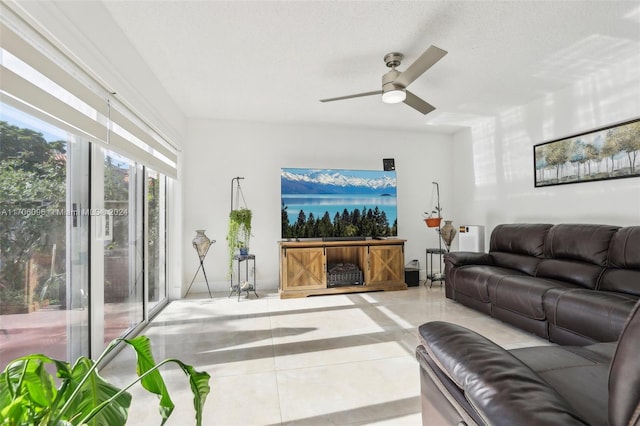 tiled living room featuring a textured ceiling and ceiling fan