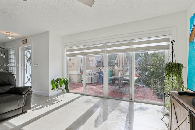 interior space with light tile patterned floors and a textured ceiling