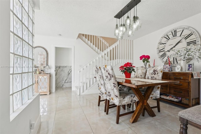 10949 Mainsail Dr, Cooper City, FL 33026 - dining space with a textured ceiling, stairs, a chandelier, and light tile patterned flooring