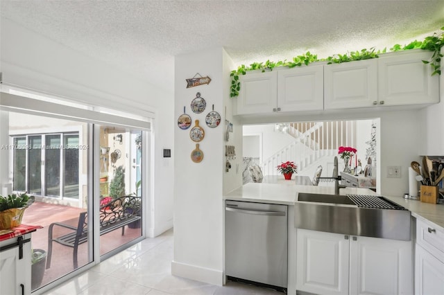 10949 Mainsail Dr, Cooper City, FL 33026 - kitchen featuring stainless steel dishwasher, light countertops, white cabinets, and a textured ceiling