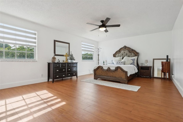 bedroom featuring a textured ceiling, hardwood / wood-style flooring, and ceiling fan