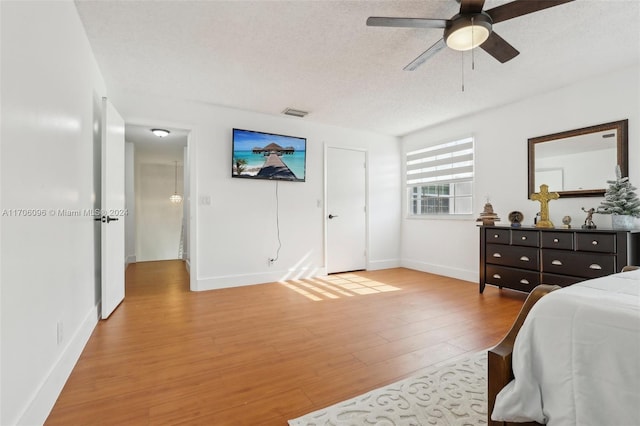 10949 Mainsail Dr, Cooper City, FL 33026 - bedroom featuring light wood-style floors, a textured ceiling, and ceiling fan