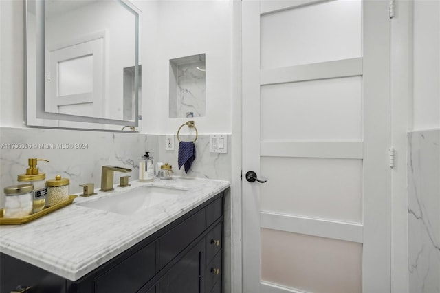 bathroom featuring vanity and decorative backsplash