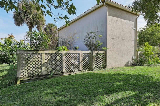 view of home's exterior with a lawn