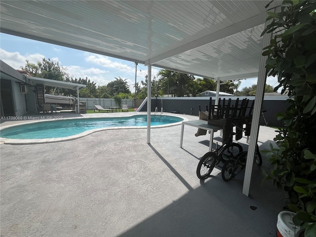 view of swimming pool with a patio