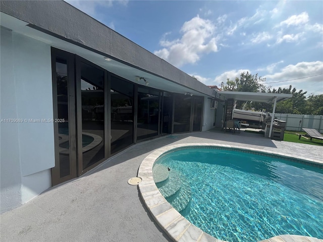 view of swimming pool featuring ceiling fan and a patio