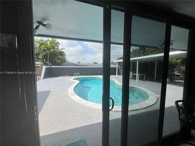 view of pool with a patio area and ceiling fan