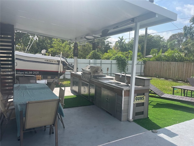 view of patio featuring area for grilling and sink