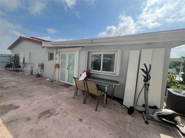 back of house featuring french doors, cooling unit, and a patio