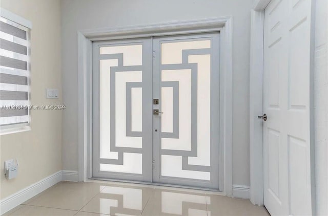 doorway with french doors and light tile patterned floors