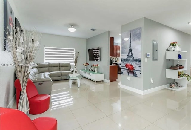 living room featuring light tile patterned floors and electric panel