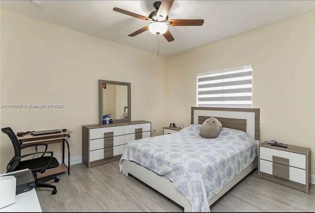 bedroom with ceiling fan and light hardwood / wood-style floors