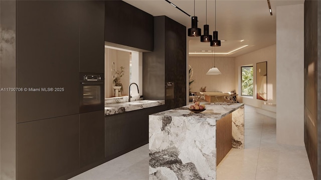 bathroom with sink, tile patterned floors, and a tray ceiling