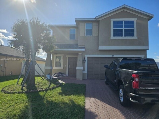 view of front of home featuring a front yard and a garage