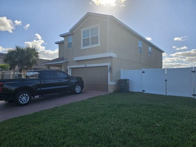 view of property exterior with a yard and a garage