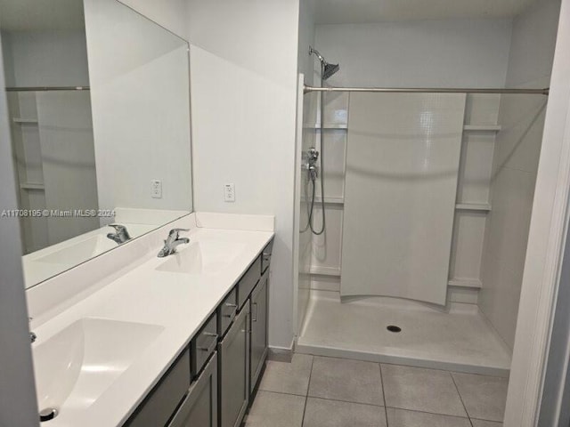 bathroom featuring a shower, vanity, and tile patterned floors