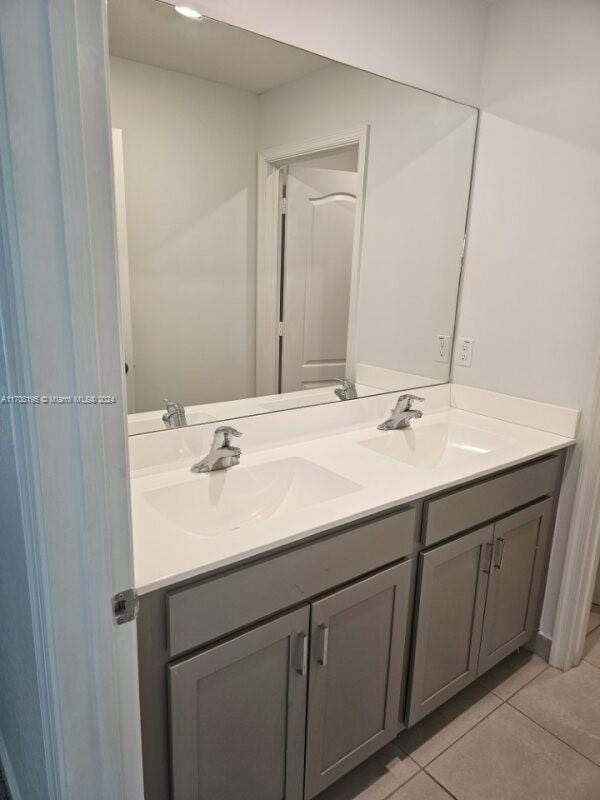 bathroom with tile patterned floors and vanity