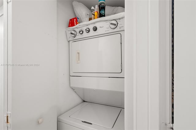 clothes washing area with stacked washer / drying machine