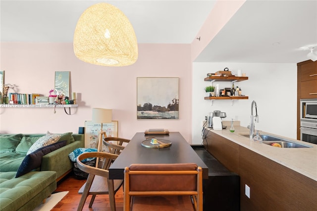 dining space featuring hardwood / wood-style flooring and sink