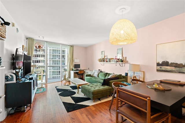 living room with hardwood / wood-style floors and a wall of windows