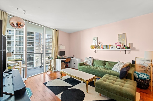 living room featuring wood-type flooring and expansive windows